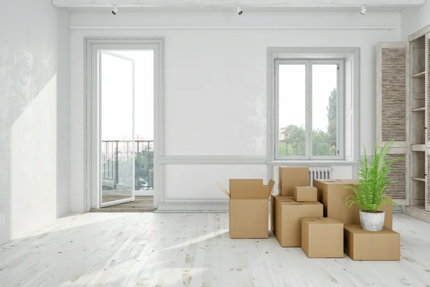 Moving boxes in an empty apartment, via iStock