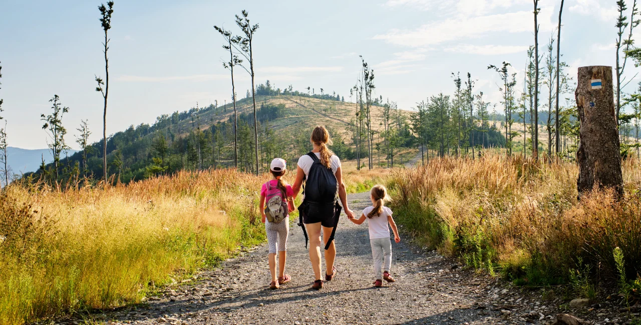 Mother and daughters hiking in the Czech countryside. Photo: iStock / Jan Nevidal
