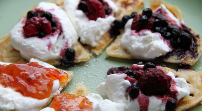 Waffles with whipped cream, fresh berries, cloudberry jam