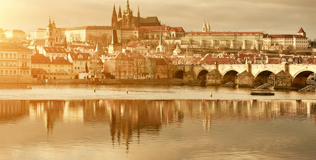 Golden Prague cityscape at sunset (illustrative image)