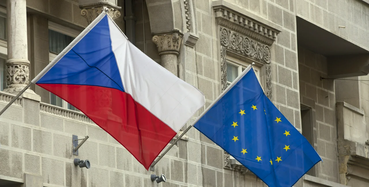 Czech Republic and European Union flags flying from poles fixed to the outside of an old building (illustrative image)