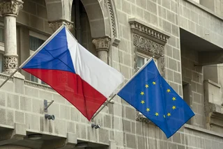 Czech Republic and European Union flags flying from poles fixed to the outside of an old building (illustrative image)
