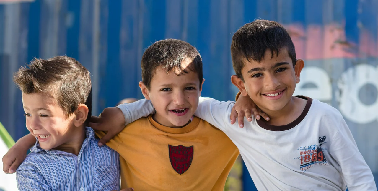 Athens, Greece - April 16, 2016: young friends in a camp for Syrian refugees