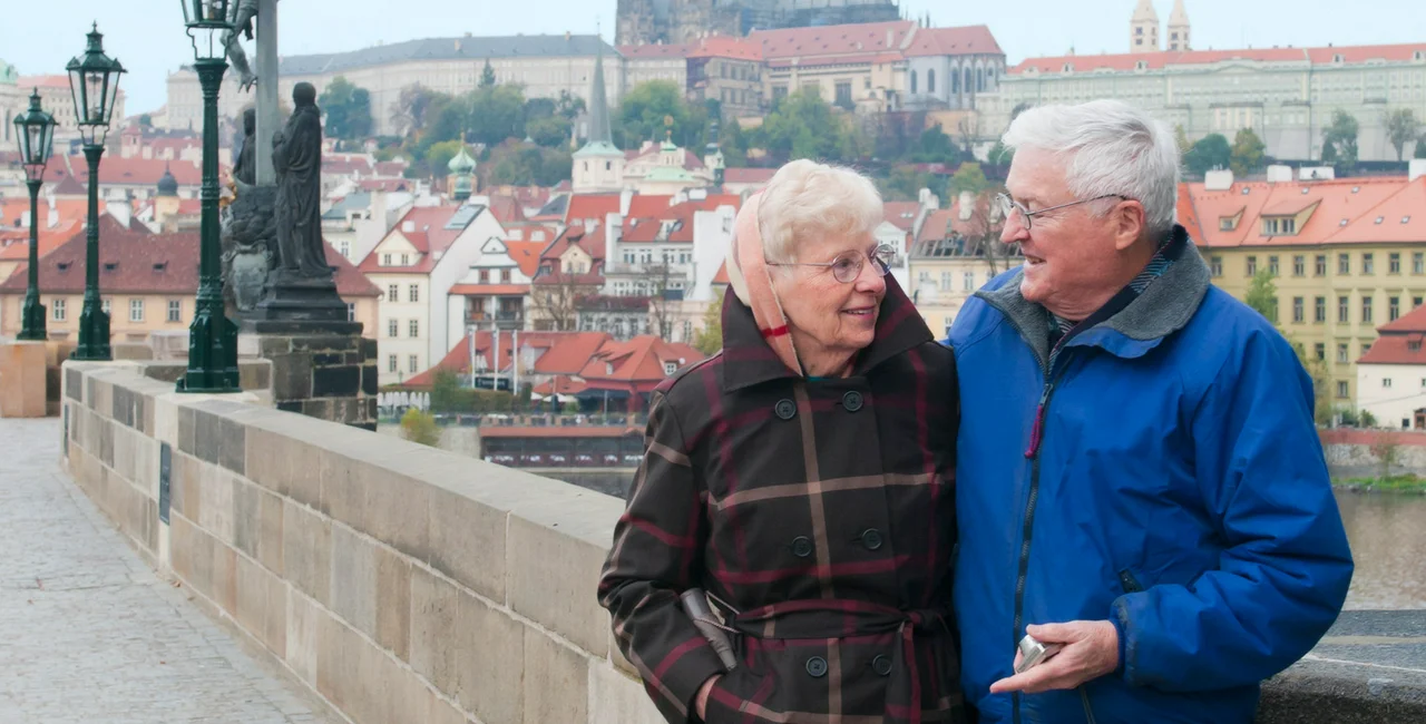 An elderly couple on Prague's Charles Bridge