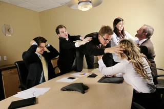 Business team fighting in the boardroom.  All graphs and charts are my own design.