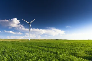 A wind turbine standing in a field