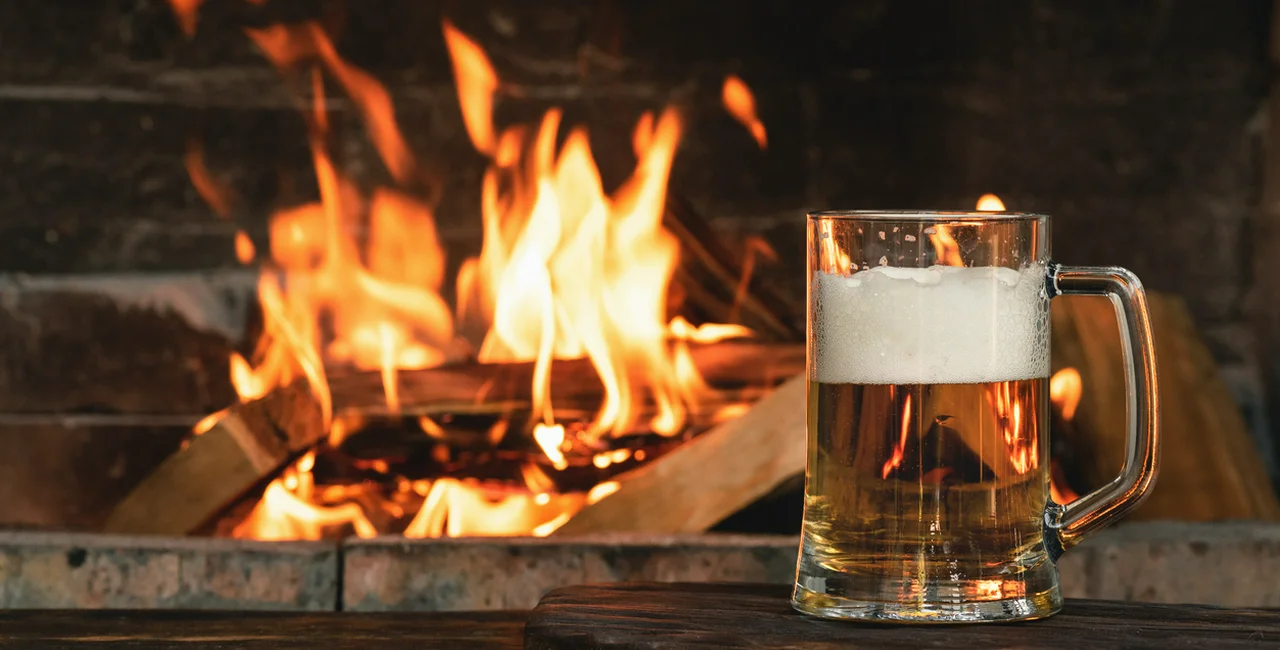 Cold beer by a warm fireplace (illustrative image)
