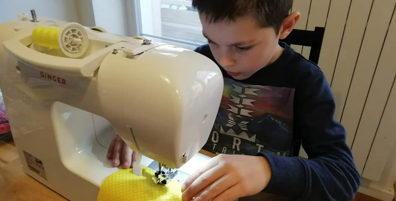 Kaja, age 8 is helping to sew masks for his friends and neighbors (photo by Angel Prince)
