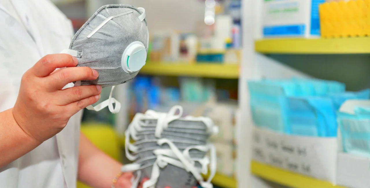 Pharmacist with an N95 respirator mask via iStock / MJ_Prototype