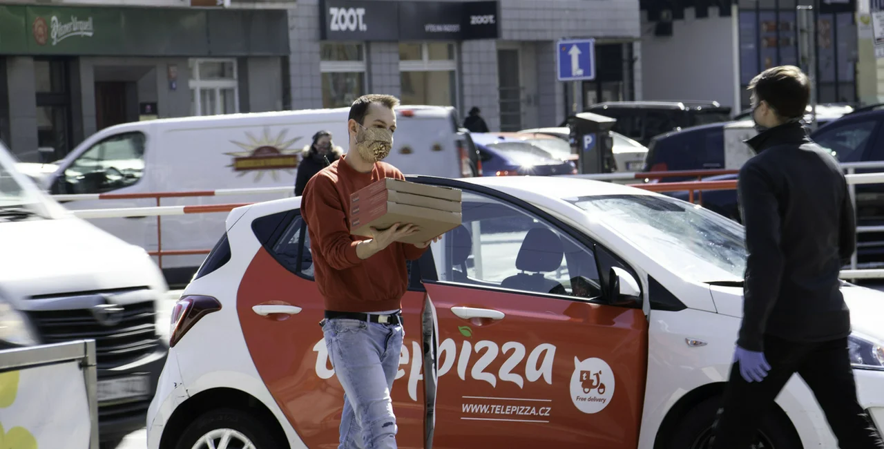 Pizza delivery in Prague during face mask regulations via iStock / Albertem