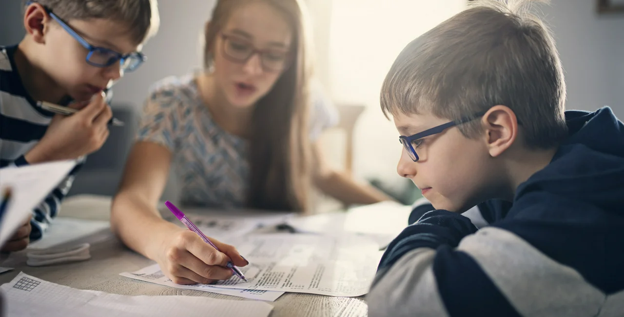 Children doing school work at home via iStock / Imgorthand