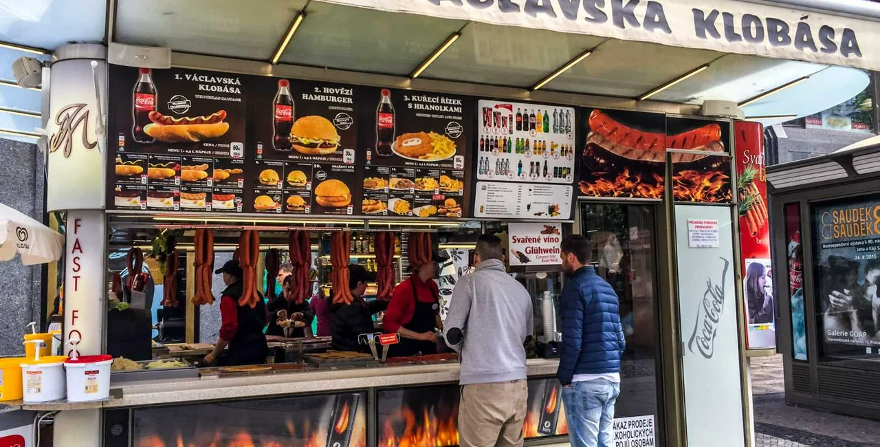 People buying fast food in a street kiosk, Prague / via iStock