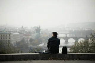 Man overlooking Prague via iStock / Chalabala