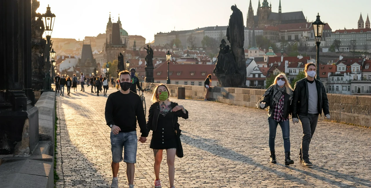 People wearing face masks on Prague's Charles Bridge during the coronavirus pandemic via iStock / Madeleine_Steinbach
