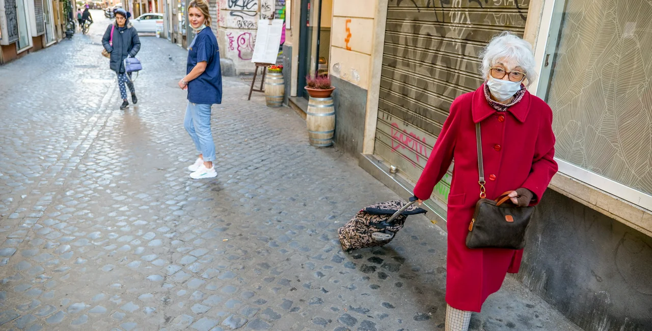Rome, Italy, March 11 -- An elderly woman protected by a medical mask goes shopping. Illustrative image via iStock / Photo Beto