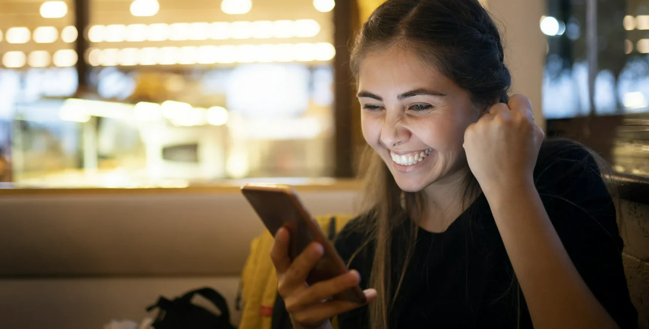 Young woman using smart phone via iStock / isayildiz