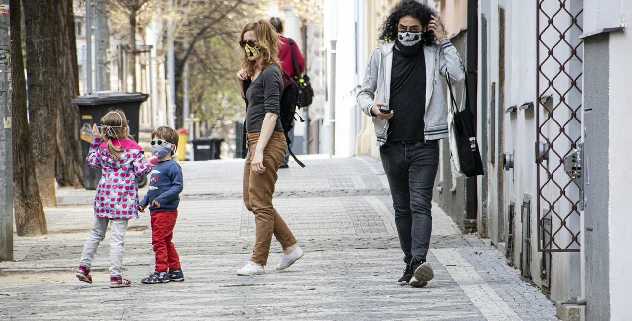 Children and adults wearing face masks on the streets of Prague