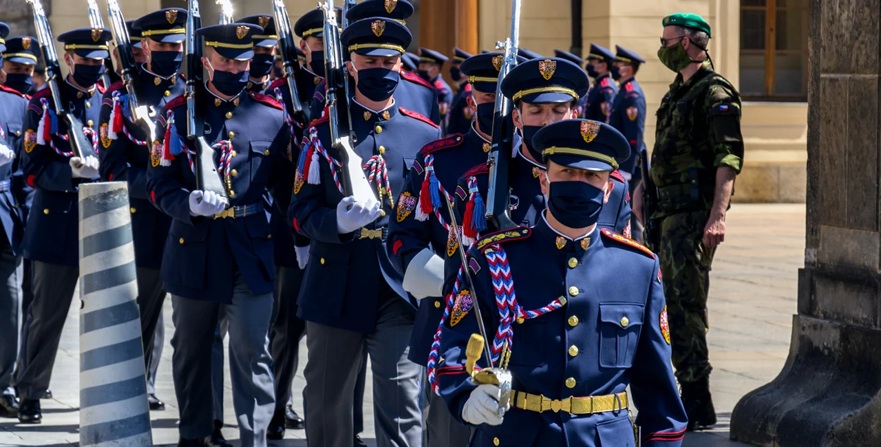 Soldiers at Prague Castle wearing face masks during the changing of the guard via iStock / josefkubes