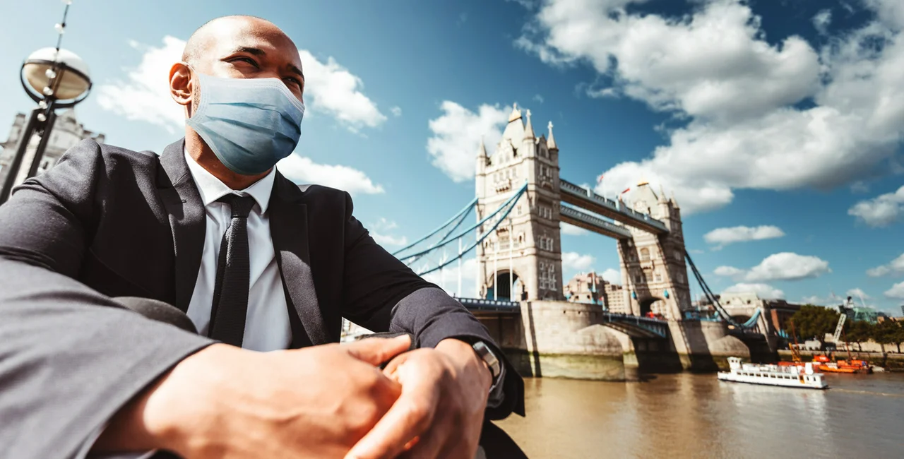 Businessman wearing a face mask by London's Tower Bridge via iStock / franckreporter