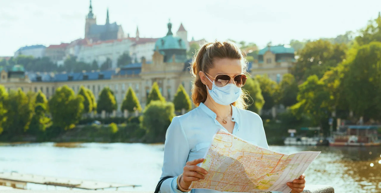 Tourist in Prague wearing a face mask via iStock / CentralITAlliance