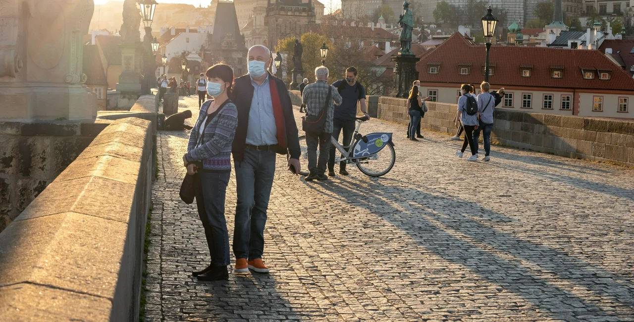 People wearing face masks on Prague's Charles Bridge at the height of the epidemic in April via iStock / Madeleine_Steinbach