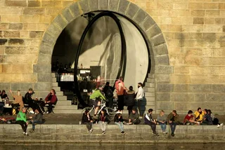 People relaxing by a cubicle at Náplavka / via Raymond Johnston