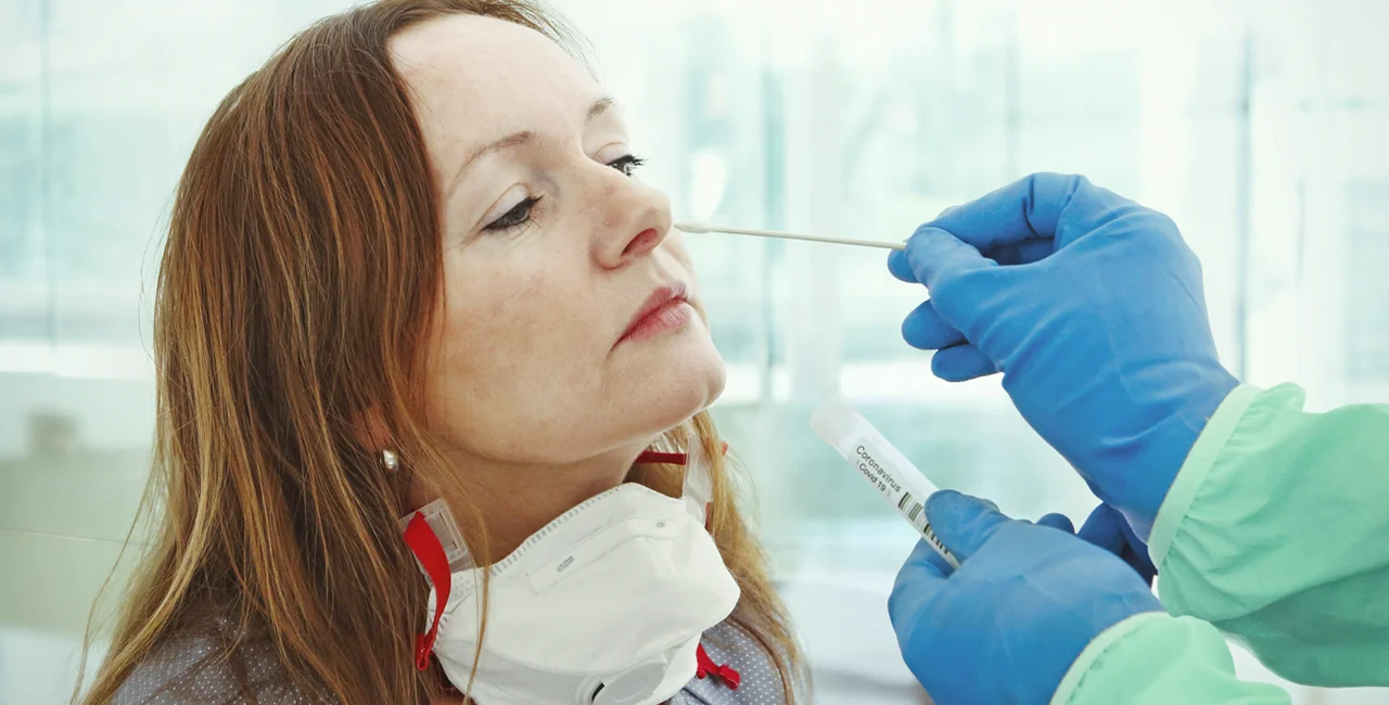 Woman taking a nasal swab PCR test for COVID-19 via iStock / narvikk