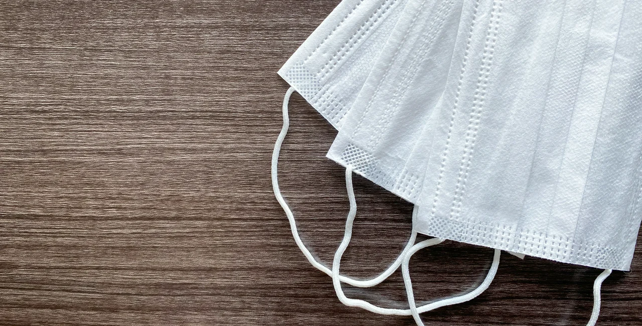Face masks on a table via iStock / Nipon Nuengpanom