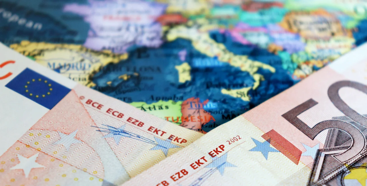 Euro banknotes over European map via iStock / Oleg Elkov