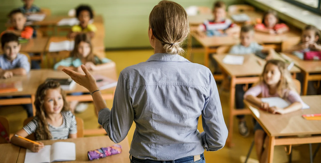 Teacher in a classroom via iStock / skynesher