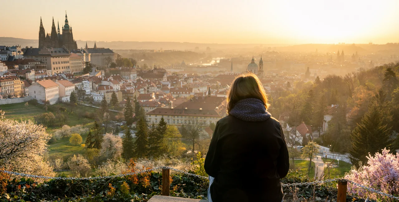 Woman overlooking Prague Castle via iStock / hopsalka