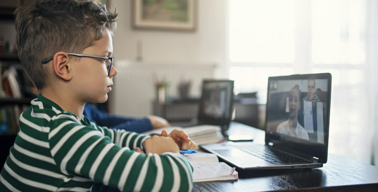 Young boy attending an online class via iStock / Imgorthand