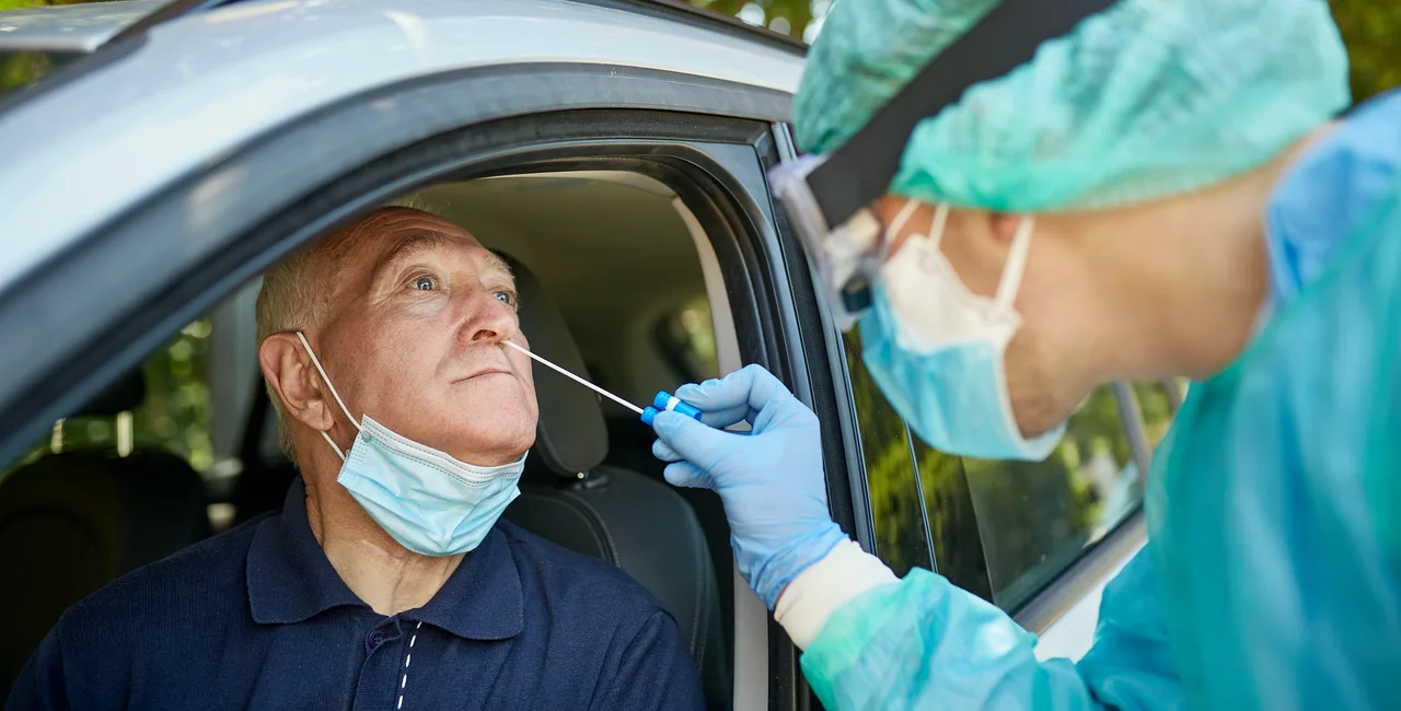 Healthcare worker collecting specimen with nasopharyngeal swab to aid in diagnosis of COVID-19 for Caucasian man in early 60s. Photo: iStock/xavierarnau