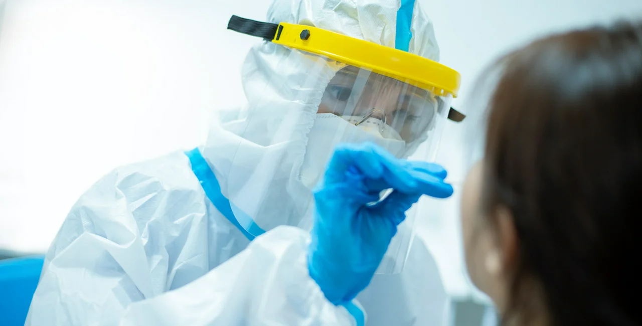 Medical worker taking a nasal swab for a COVID-19 test via iStock / RyanKing999