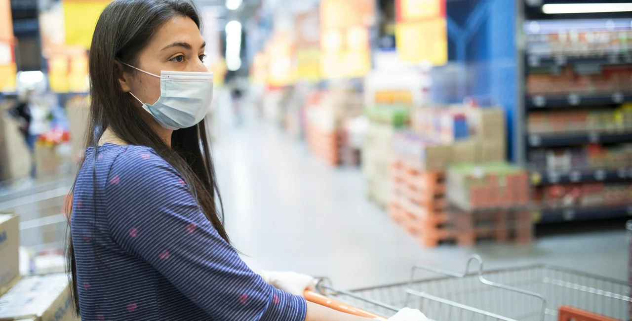Woman wearing a face mask in a supermarket via iStock / vlada_maestro