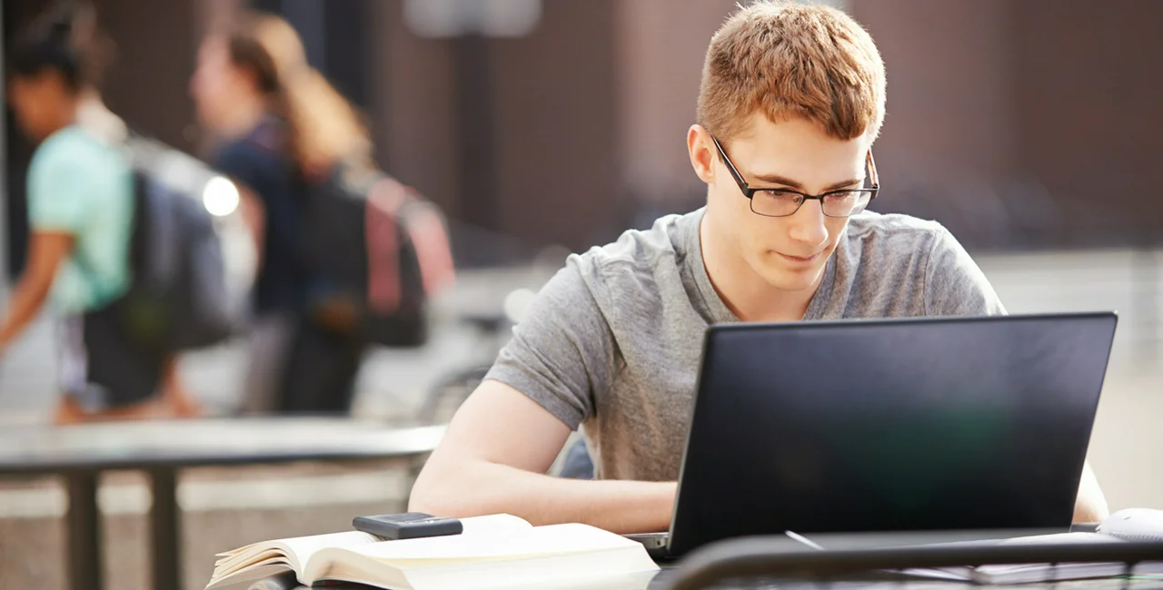 Teenager using a computer at school via iStock / AJ_Watt