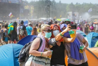 People wearing face masks at a music festival via iStock / ewg3D