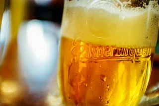 Glass of Pilsner Urquell beer via iStock / Nikada