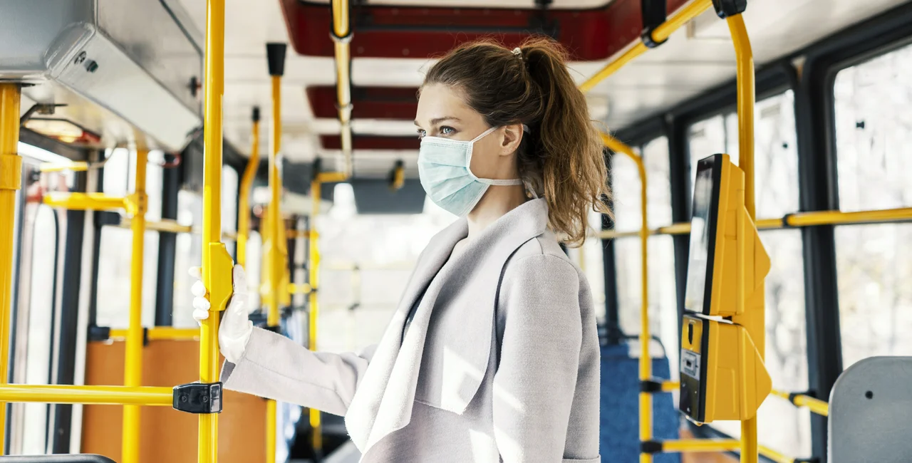 A woman wearing a face mask rides the bus during the COVID-19 pandemic. Photo: iStock/Adrian Seliga