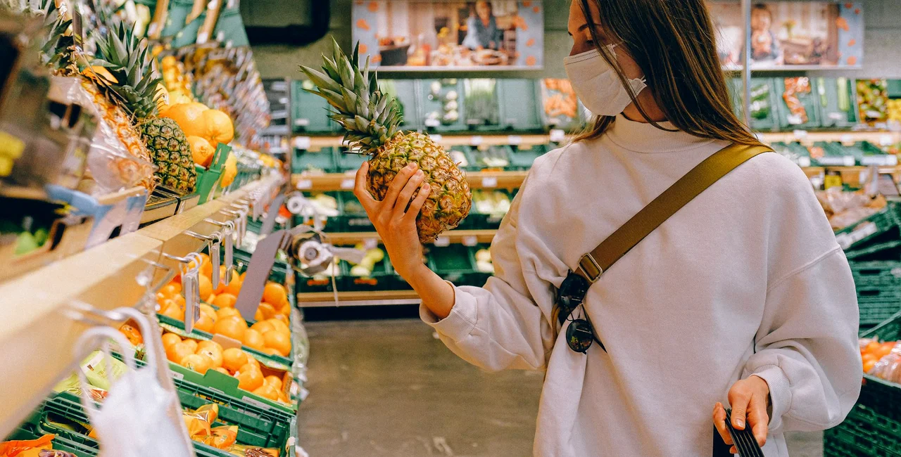 A woman wears a mask as she shops for groceries. Photo by Anna Shvets from Pexels
