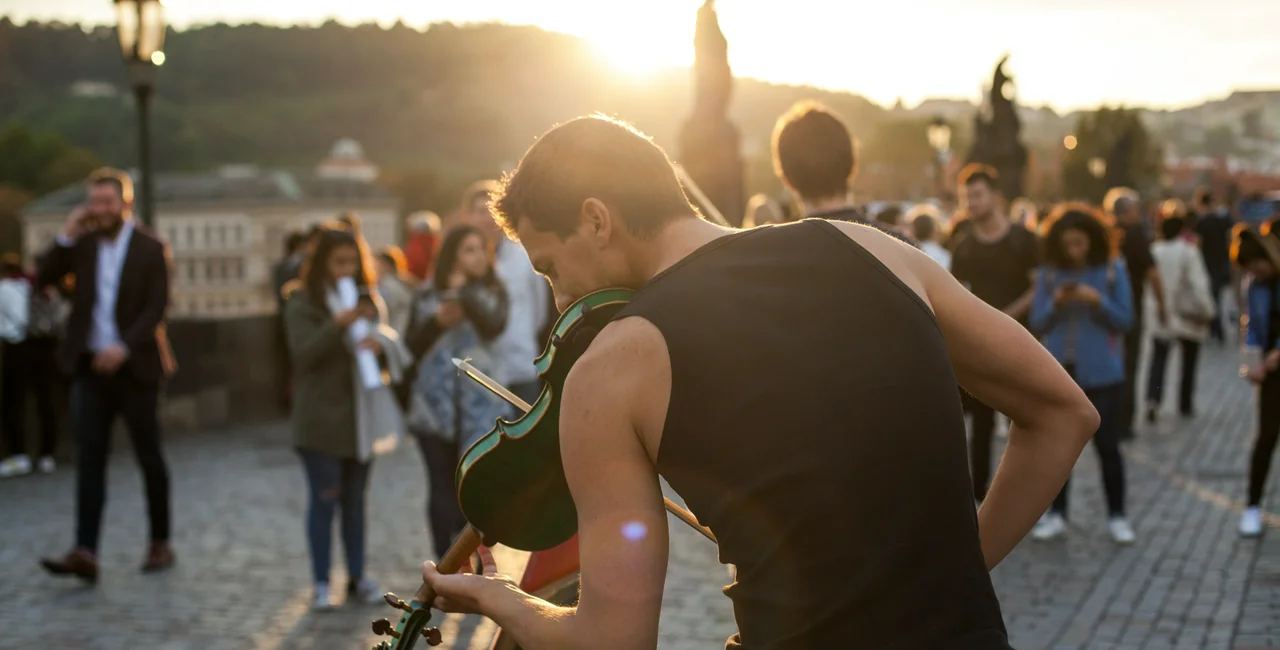 Street musician on Prague's Charles Bridge via iStock / agrobacter