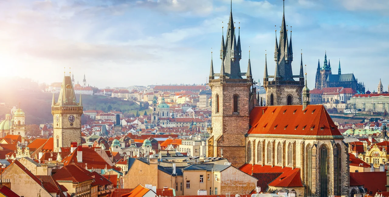 Church spires and rooftops in central Prague via iStock / Yasonya