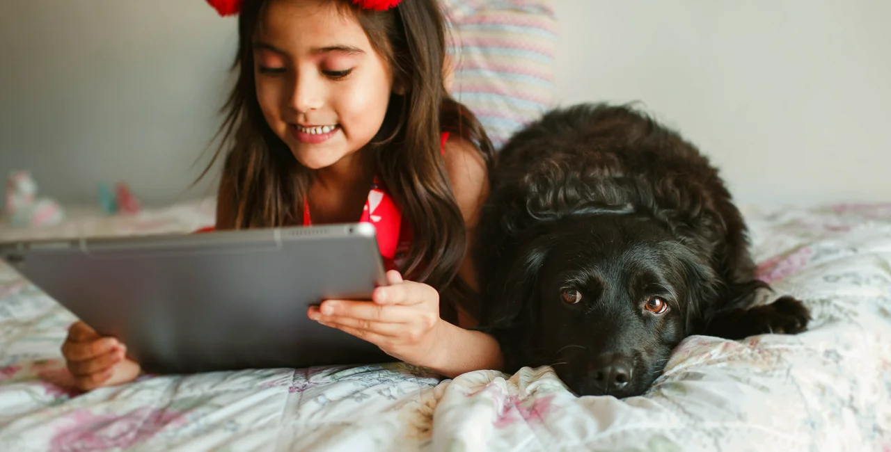 girls with tablet and dog
