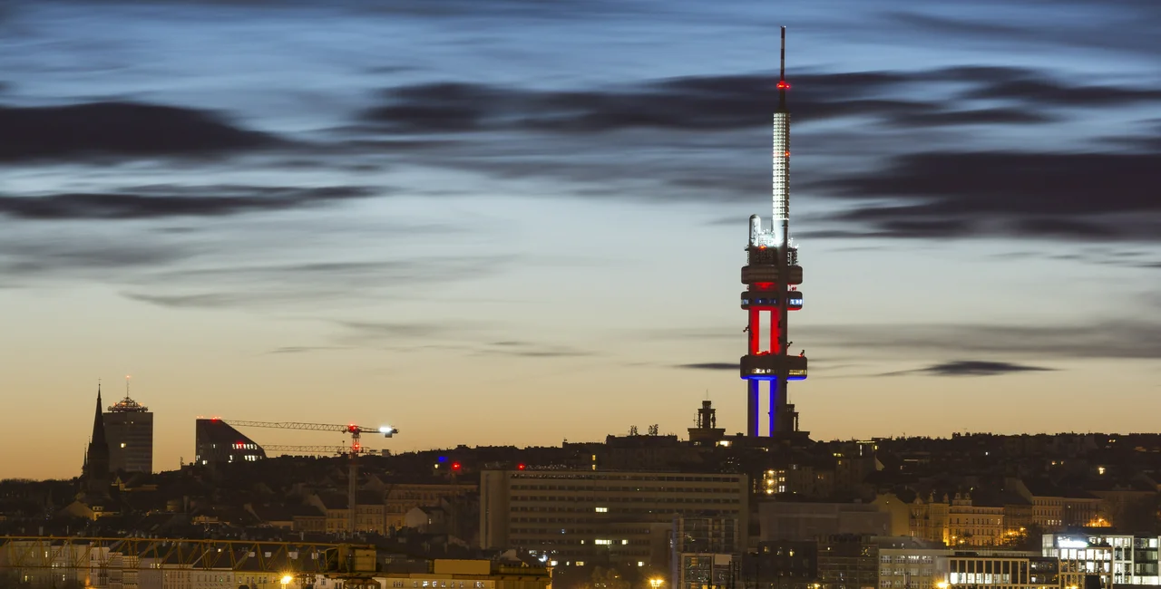 Prague skyline with the Žižkov TV Tower lit up in the colors of the Czech flag via iStock / arsenisspyros