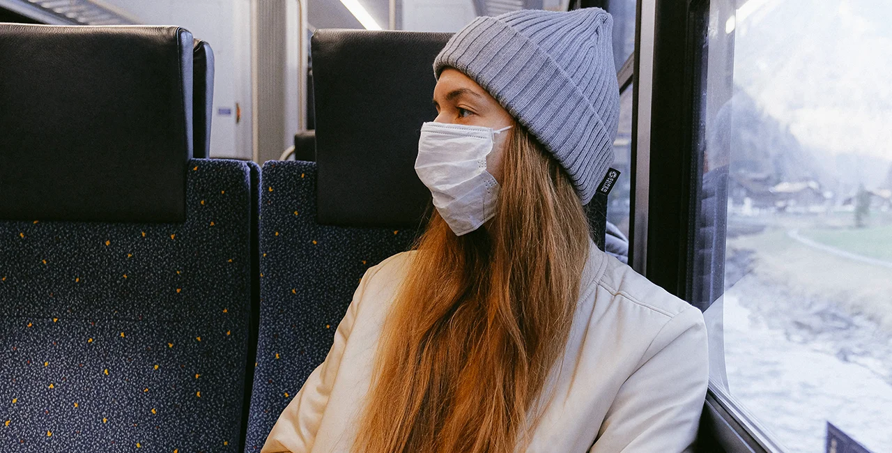 Woman on train wearing a face mask. Photo by Anna Shvets from Pexels