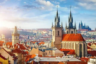 Church spires and rooftops in central Prague via iStock / Yasonya