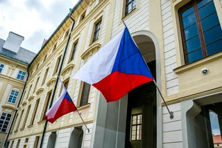 Czech flags hang outside a government building in Prague, via iStock / Konoplytska