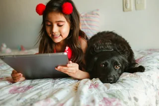 girls with tablet and dog