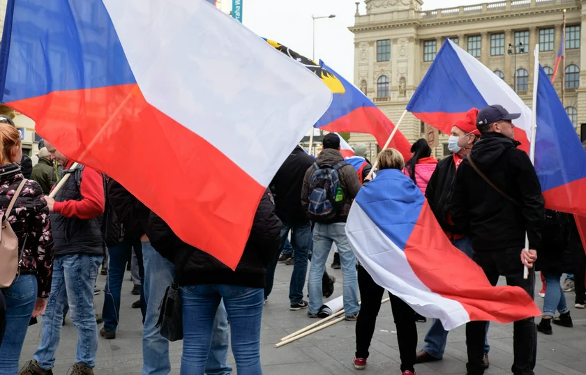 People gather atop Wenceslas Square draped in Czech national flags during the rally. (photo: James Fassinger - Expats.cz)