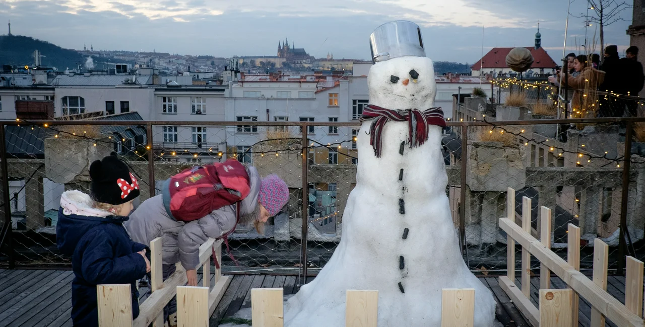 Children investigate a snowman on Lucerna terrace during the annual Mikulas celebration. (photo: James Fassinger - Expats.cz)